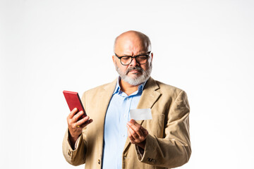 Indian asian senior old aged man using smartphone against white background.