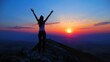 © Zainab - A woman, in celebration of reaching the summit of a mountain peak at sunset or sunrise, holds her arms high above her head in elation