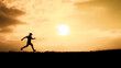 © STOCK PHOTO 4 U - Silhouette of a Runner at Sunset with Golden Sky and Sun in the Background, Capturing the Essence of Outdoor Fitness and Nature