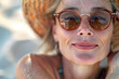 © Oksana_Latysheva - Closeup portrait of beautiful smiling mature Woman in Sunglasses, sunbathing her faces under the beautiful sun of summer by the beach