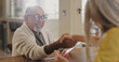 © peopleimages.com - Handshake, insurance or pension with senior man meeting finance broker in home for advice or deal. Agreement, contract or documents and elderly person shaking with agent in assisted living apartment