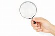 © Jakraphong - Hand Holding Magnifying Glass on White Background
