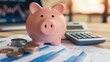 © MarkFinal - A piggy bank next to a calculator and financial documents