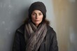 © CogniLens - Portrait of a satisfied woman in her 50s dressed in a warm ski hat in bare monochromatic room