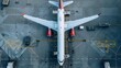 © Usman - Top view of a passenger plane parked at the departures hall of an international airport. The plane is prepared for departure and refueled by the airport's technical service
