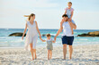 © peopleimages.com - Travel, beach and family for children walking by sea for bonding, holding hands together and relaxing in nature. Father, trust and happy mom with kids by ocean on holiday, vacation and adventure