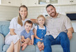 © peopleimages.com - Portrait, smile and family relax on sofa house for bonding, love and care or hug in living room together. Happy, woman and man with children for childhood, support and trust of memory at home