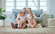 © Delcio Fernandes/peopleimages.com - Family, care and parents with kids in portrait, happiness and together on home living room floor. People, bonding or smile with love, mother and father relax with children in dream home lounge