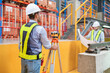 © Washburn - Engineer uses equipment to survey the level of railroad tracks in a maintenance plant.
