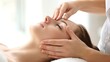 © Irina Ukrainets - Relaxing facial massage in a spa setting by professional therapist. This image captures a peaceful moment of a woman receiving a rejuvenating treatment.I