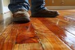 © denklim - A Man Walking on Newly Finished Hardwood Floors