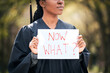 © peopleimages.com - Woman, graduate and uncertain with now what sign for future with worried, fear and doubt for career. African, female person and placard with stress, anxiety or crisis of unemployment in United States