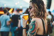 © Tymofii Borysenko - Woman with tattoo and beer at a music festival