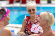 © Luluraschi - retired caucasian senior women playing cards and enjoying summer vacations at an all inclusive hotel resort, wealthy people