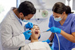 © Lumeez23/peopleimages.com - Dentist, team and oral care with patient for healthcare, wellness and teeth whitening in practice. Woman, dental professional and PPE with tools for consultation, cleaning and filling on chair