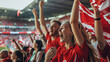 © AriyaniAI - Denmark football supporter fans cheering with confetti watching soccer match event at stadium - Young people group with red t-shirts having excited fun on sport european championship concept
