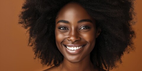Black woman with self-love, grin, and hair care on a brown studio background. Style, healthy growth, African model with glow, attractiveness, or wellness skincare thoughts