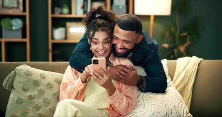 Canvas Print - Couple, happy and couch for hug with smartphone, smile and love in home for relationship bonding together. Lounge, woman browsing and man laugh for meme on social media, affection and reading post