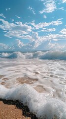 Wall Mural - A refreshing background of frothy sea waves crashing on a sandy shore under a bright sky