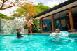 © Brocreative - A  family enjoys playing in their private swimming pool while on vacation as they enjoy a short-term vacation rental property. Family lifestyle and leisure photo
