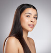 © peopleimages.com - Hair care, glow or woman with beauty, portrait or style for confidence, results or keratin treatment. Face, shine or girl model in studio on grey background for wellness, natural growth or cosmetics
