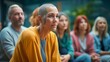 © Ratthamond - Supportive community for cancer patients: A diverse group in their thirties, with shaved heads and facial tattoos, gathers for a meeting.