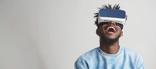 Wall Mural - A man wearing VR glasses laughing while standing against white background