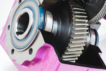 Canvas Print - A close up of a gear with a blue and white circle in the middle. The gear is pink and has a black and silver color