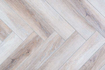 Poster - A wooden floor with a checkered pattern. The floor is made of wood and has a light color. The checkered pattern is made up of many small squares, creating a visually interesting design