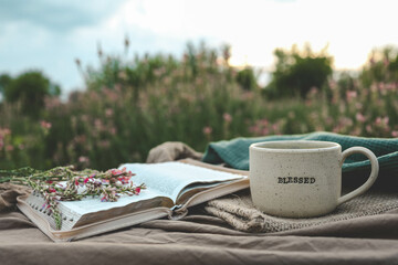 Canvas Print - Cup with text BLESSED and open Bible in the garden, good morning