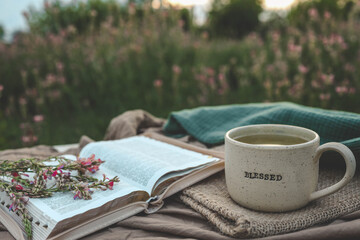 Wall Mural - Cup with text BLESSED and open Bible in the garden, good morning