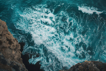 Wall Mural - The ocean is calm and peaceful, with gentle waves lapping against the rocks