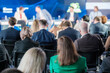 © Anton Gvozdikov - Group of professionals attending a business seminar, facing speakers on stage, discussing various topics at a conference.