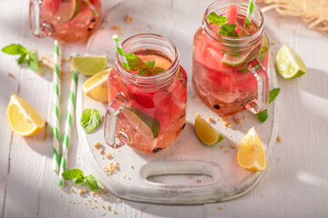 Wall Mural - Cold and tasty lemonade with citrus, melon and crushed ice.