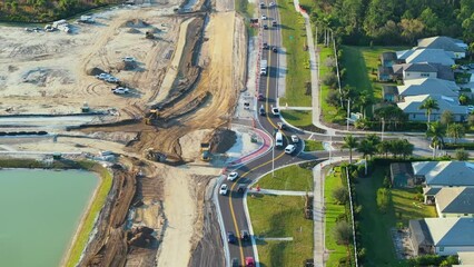 Wall Mural - Roadworks construction site at roundabout intersection on American highway. Development of city circular transportation crossroads.