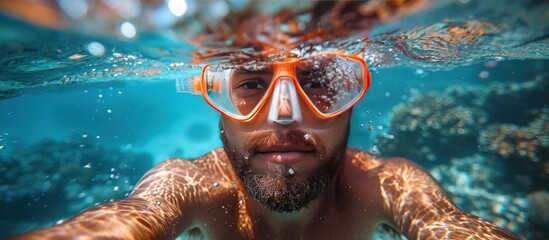 man swimming snorkeling underwater with life jacket