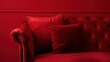 © Matthew - An elegant red velvet sofa with matching pillows against a red wall, showcasing a monochromatic luxury decor
