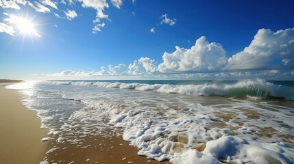 Wall Mural - A panoramic view of a tranquil beach under a clear blue sky with the sun shining and gentle waves crashing ashore