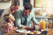 © Reese Coop/peopleimages.com - Home, parents and boy with breakfast, conversation and meal in kitchen, bonding together and talk. Family, mother and father with kid, healthy food and love with nutrition, wellness and care in house