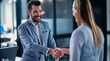© yj - A young business man shaking hands with a female employee in the office.