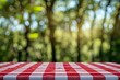 © HRStudio - Close up countertop with red and white checkered table cloth on blured nature background, for your product