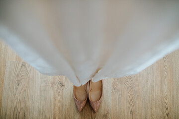 Wall Mural - Bridal shoes seen through the wedding dress