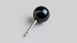 © Ева Поликарпова - A single black pin with a silver tip resting on a white background