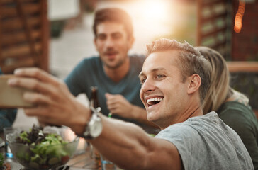 Canvas Print - Laughing, friends and selfie of man at dinner party for celebration at social gathering. Food, picture and group of people eating lunch together at event, reunion and excited for happy memory at home