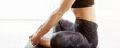 © Prostock-studio - Cropped of woman is seated on a yoga mat in a gym, stretching and performing yoga exercises during her morning workout, wearing athletic wea, emphasizing flexibility and mindfulness, panorama