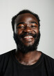 © tinyt.studio - A middle age black african american guy with moustache and beard smiling at the camera grey background