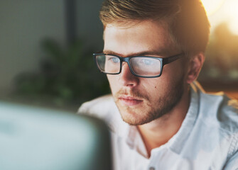 Wall Mural - Man, computer and night in office for task, research and web designer for proposal. Male person, employee and networking or website for online consulting, project management and pc on late shift