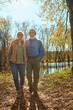 © Reese Coop/peopleimages.com - Travel, nature and senior couple in forest with backpack for walk, exercise and bonding together. Happy, love and elderly man and woman in retirement enjoying view by woods in Autumn in England.