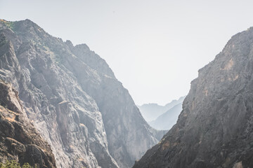 Wall Mural - Rocky mountain range in Tajikistan in the haze early sunny morning in the sun's rays, landscape of the Pamir Mountains for the background texture, the valley of the Panj River