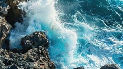 Wall Mural - Wave in the ocean crashing against the rocks